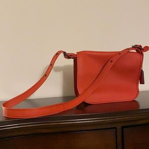 Medium sized Coach crossbody. Color is orange. Excellent condition